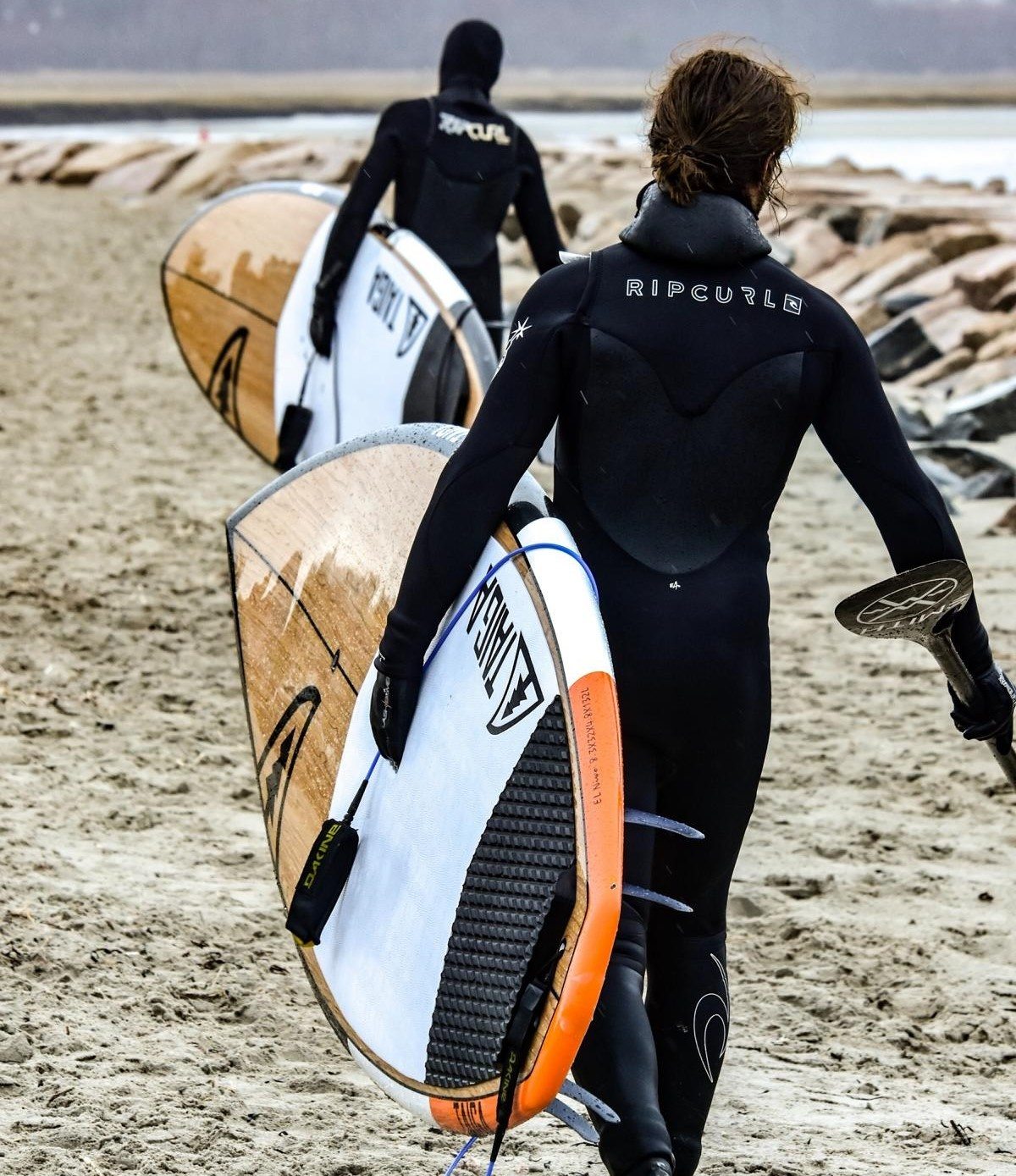 two surfers at the beach with same interest
